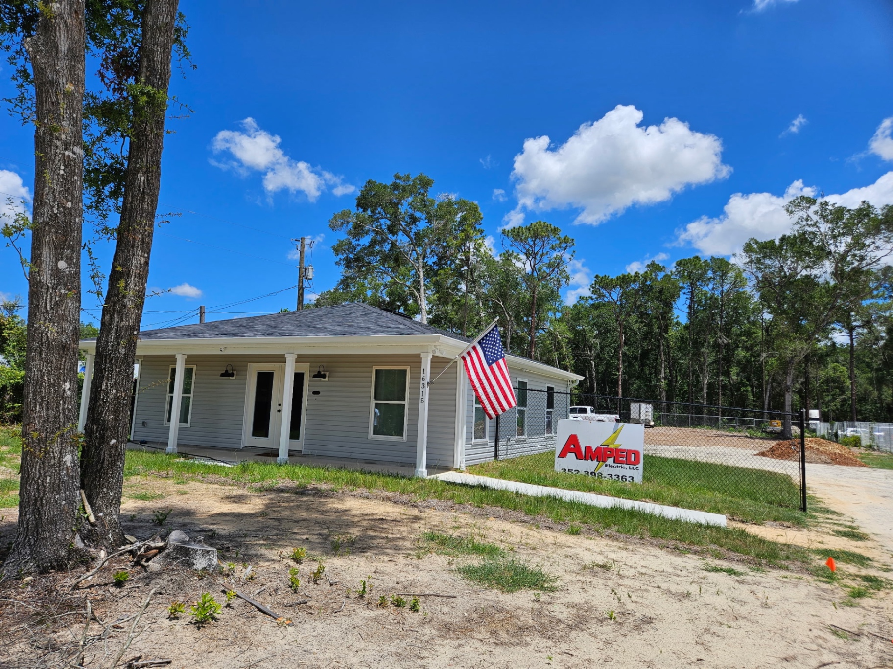 Amped Electric office in Brooksville, FL with company sign out front